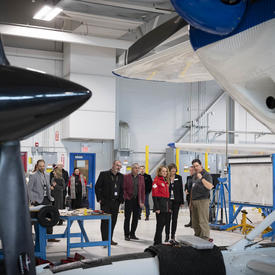 The Governor General in the Aviation Centre of Excellence hangar with students, teachers and aircraft.
