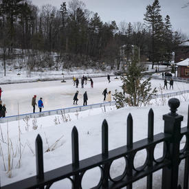 A photo of the Rideau Hall skating rink taken from above, bustling with skaters.