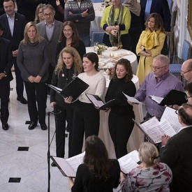 The Governor General sings with the choir inside the Tent Room at Rideau Hall during the Winter Diplomatic Reception.