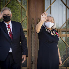 Mary May Simon and her husband wave to people outside of Rideau Hall.