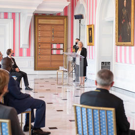 Governor General Mary May Simon stands at a podium addressing a crowd.