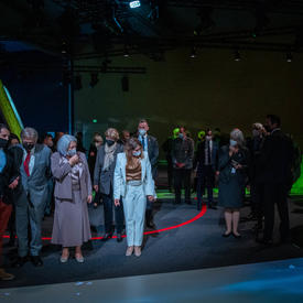  Their Excellencies are standing in a small group admiring the light show at the Canada Pavilion. 