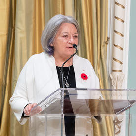 Governor General Mary May Simon stands at a podium addressing a crowd.