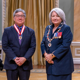 Geoffrey Fong is standing next to the Governor General.