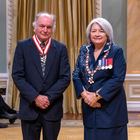 Ian Tamblyn is standing next to the Governor General.