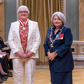Lori West is standing next to the Governor General.