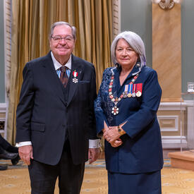 Guy Berthiaume is standing next to the Governor General.