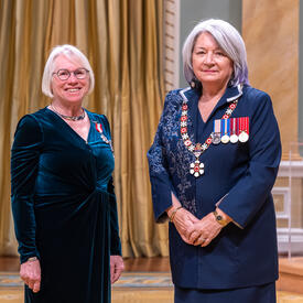 Mary Ruth Brooks is standing next to the Governor General.