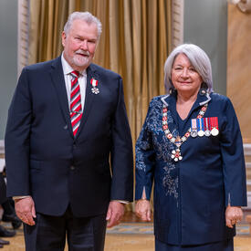 David Grimes is standing next to the Governor General.