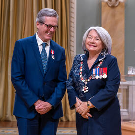 Glenn Peter O’Farrell is standing next to the Governor General.