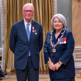 Kenneth L. Wilson is standing next to the Governor General.