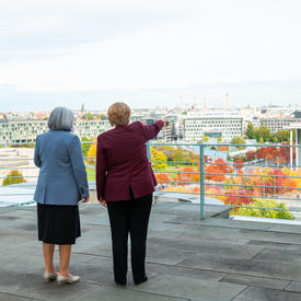  View from behind of Her Excellency and Angela Merkel admiring the city’s landscape.