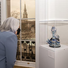 Governor General Mary Simon looking at an item on display at Canada House.