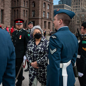 Governor General Simon is walking past members of the Canadian Armed Forces at Queen’s Park.
