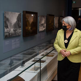 Governor General Mary Simon is touring a historical exhibit and inspecting different displays.