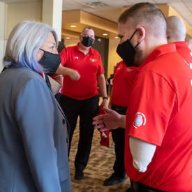 Governor General Mary Simon is speaking with a member of Team Canada.