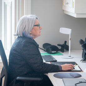 La gouverneure générale est assise devant un ordinateur. Elle participe à un événement virtuel.