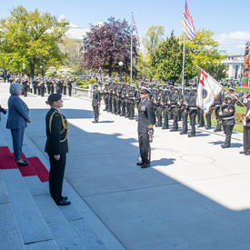 Governor General Simon is inspecting a guard of honour.