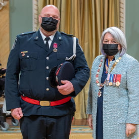 Auxiliary Constable Max Milan standing next to the governor general.