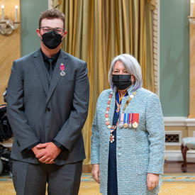 Connor Stanle standing next to the governor general.