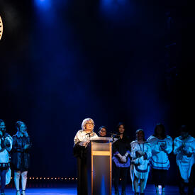 The Governor General standing at a podium.