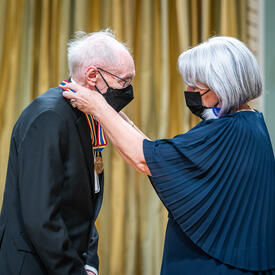 Fernand Dansereau, film and television screenwriter, director and producer, receiving an award from the Governor General.