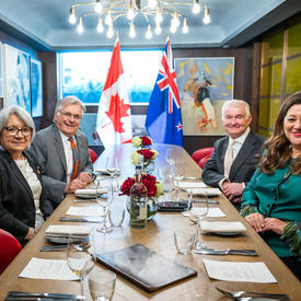 Governor General Simon and Dame Cindy Kiro, Governor General of New Zealand, are sitting at a large table. Their husbands are also there.