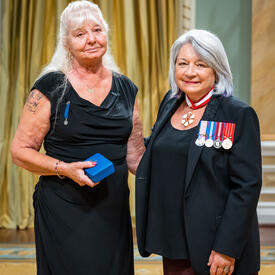 Terry Lynn Stewart is standing next to the Governor General.