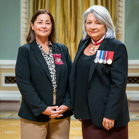 Bravery recipient Margaret Irene Bell is standing next to the Governor General.