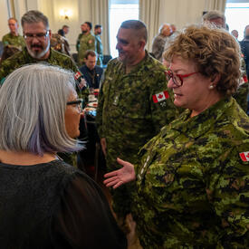 Governor General Simon is speaking with a member of the Canadian Armed Forces.