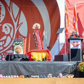 Governor General Mary Simon is standing on a stage behind a podium. She is speaking into a microphone.