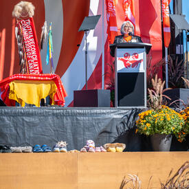 Governor General Mary Simon is standing on a stage behind a podium. She is speaking into a microphone.