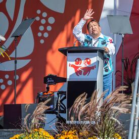 A man is standing at the podium on the stage.