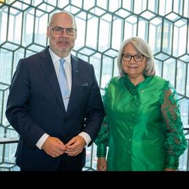 The Governor General is standing next to His Excellency, Alar Karis, President of the Republic of Estonia. There is a large patterned glass wall behind them.