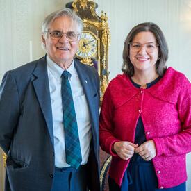 Mr. Fraser is standing next to Mrs. Eliza Reid, the First Lady of Iceland.