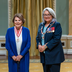 Janette Bertrand is standing next to the Governor General.