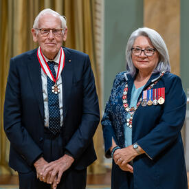 Jan den Oudsten is standing next to the Governor General.