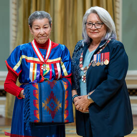 Elder Doreen Spence is standing next to the Governor General.