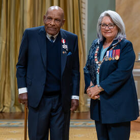 B. Denham Jolly is standing next to the Governor General.