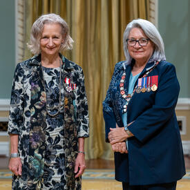 Sara Louise Diamond is standing next to the Governor General.