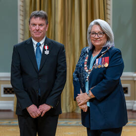 Michel Doucet is standing next to the Governor General.