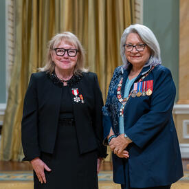 Roxanne Fairweather is standing next to the Governor General.