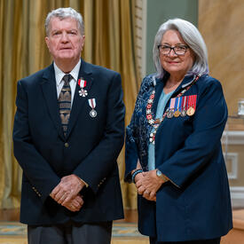 Gary Gullickson is standing next to the Governor General.