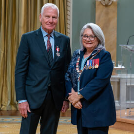 Tony Hauser is standing next to the Governor General.