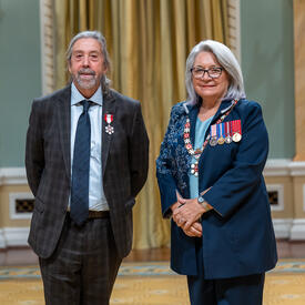 Louis Paquin is standing next to the Governor General.