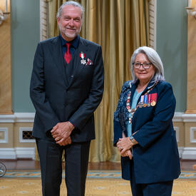 Michael Dixon Smith is standing next to the Governor General.