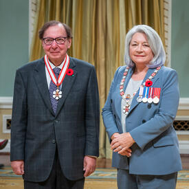 Howard Alper is standing next to the Governor General.