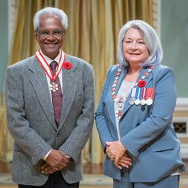 Neil Devindra Bissoondath is standing next to the Governor General.