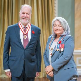 Graham Fraser is standing next to the Governor General.