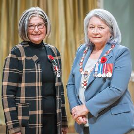 N. Louise Bradley is standing next to the Governor General.
